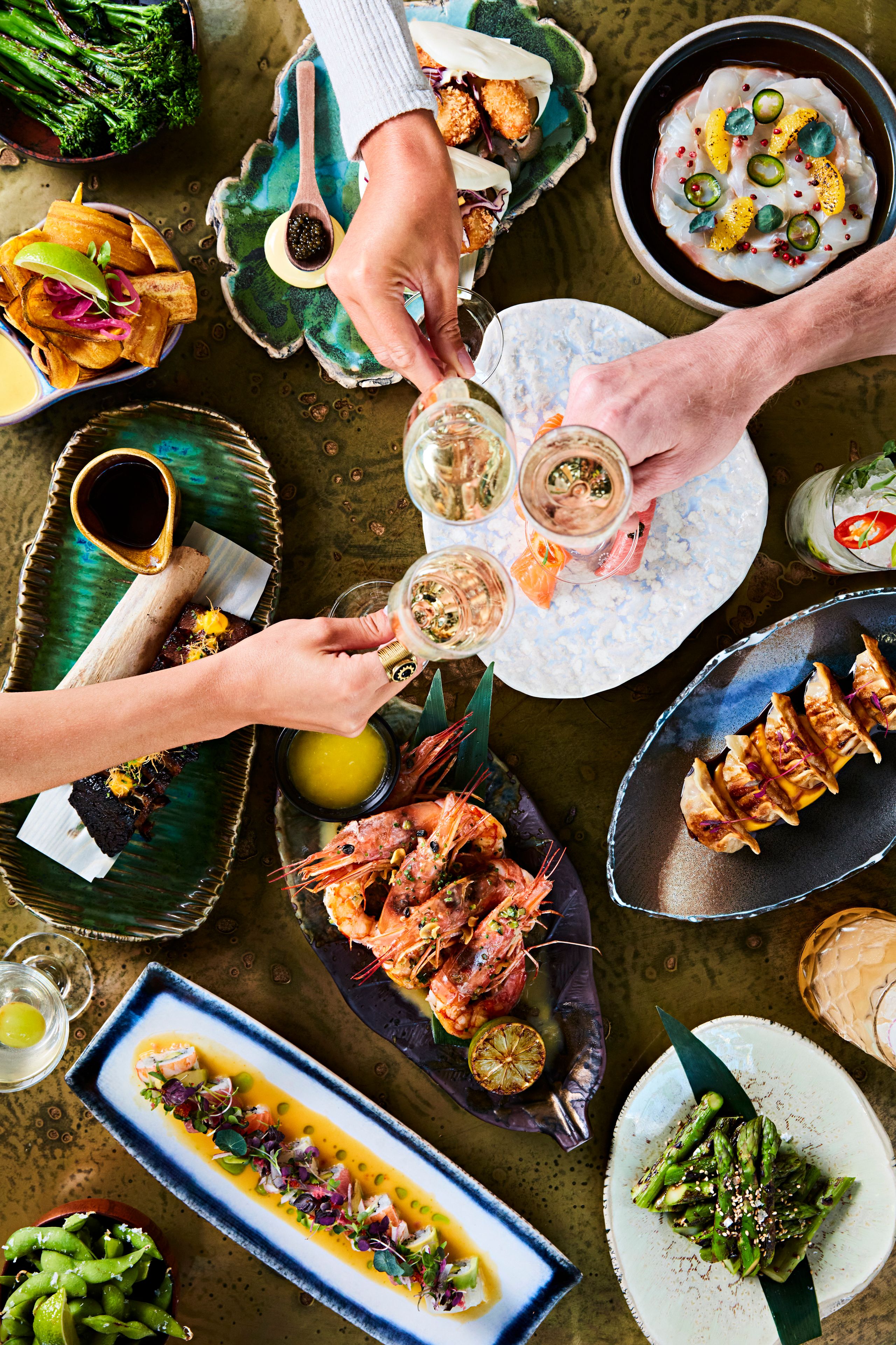 SUSHISAMBA menu with variety of dishes and guests toasting