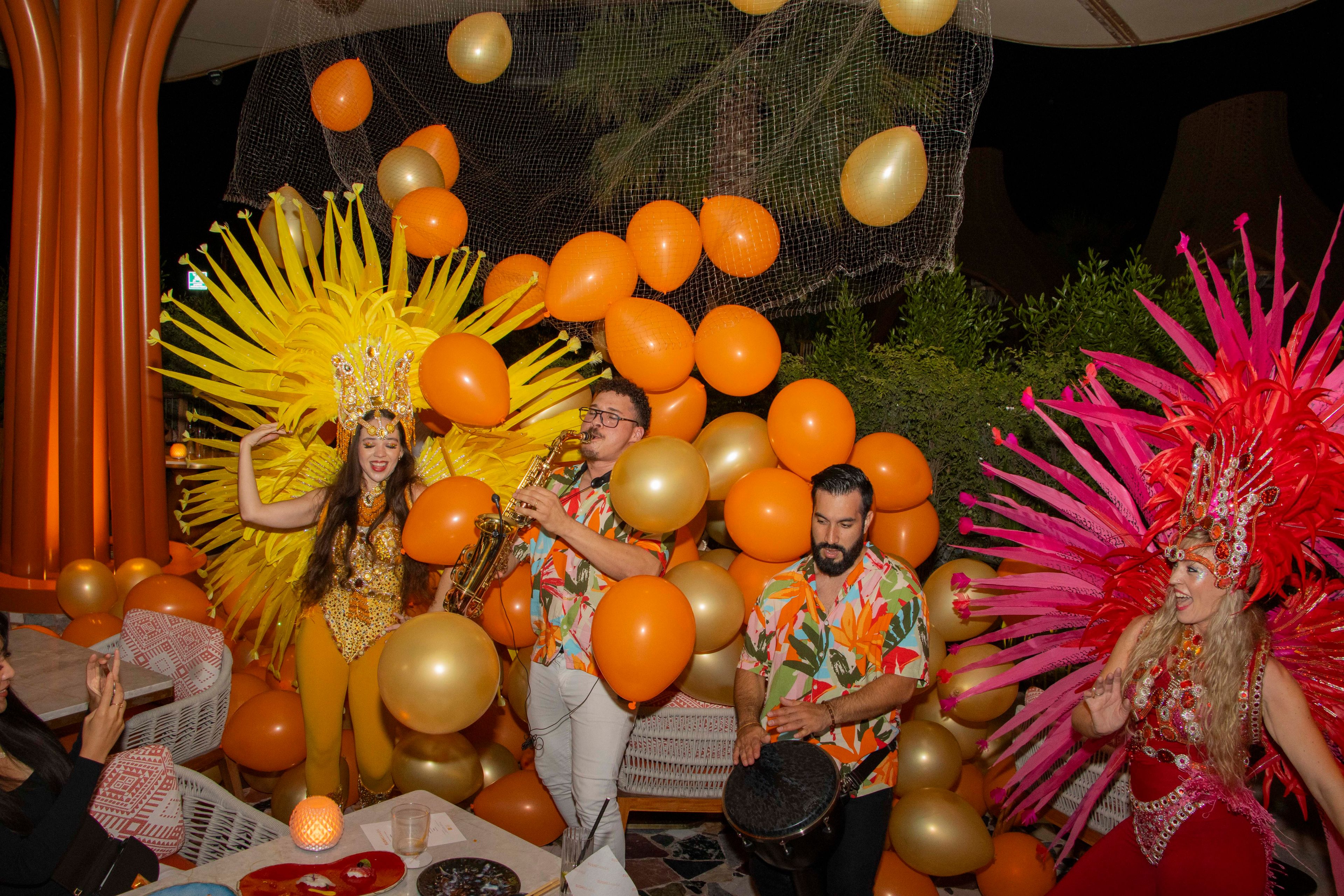 SUSHISAMBA DOHA Samba BRUNCH celebration with performers and orange balloons