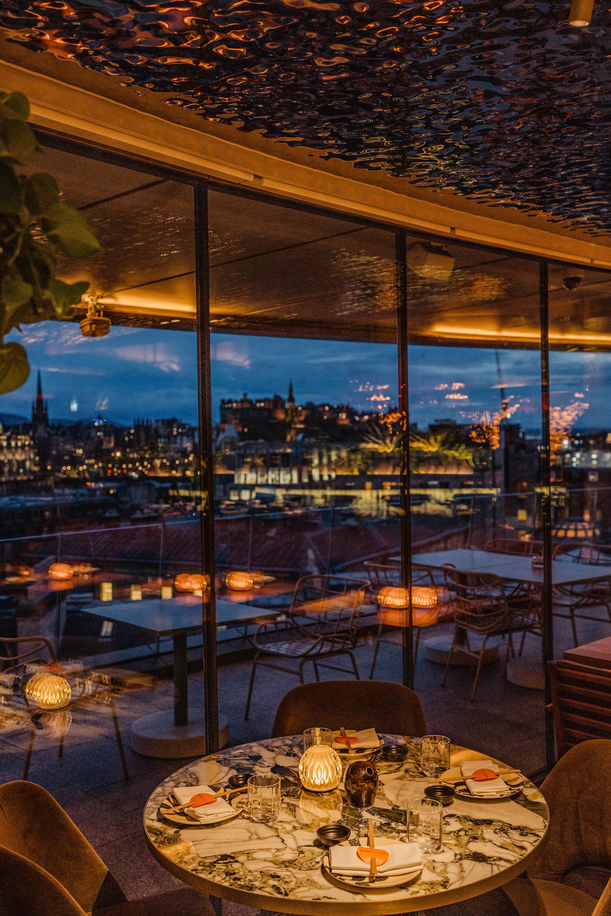 SUSHISAMBA Edinburgh restaurant table at night with a view of the castle