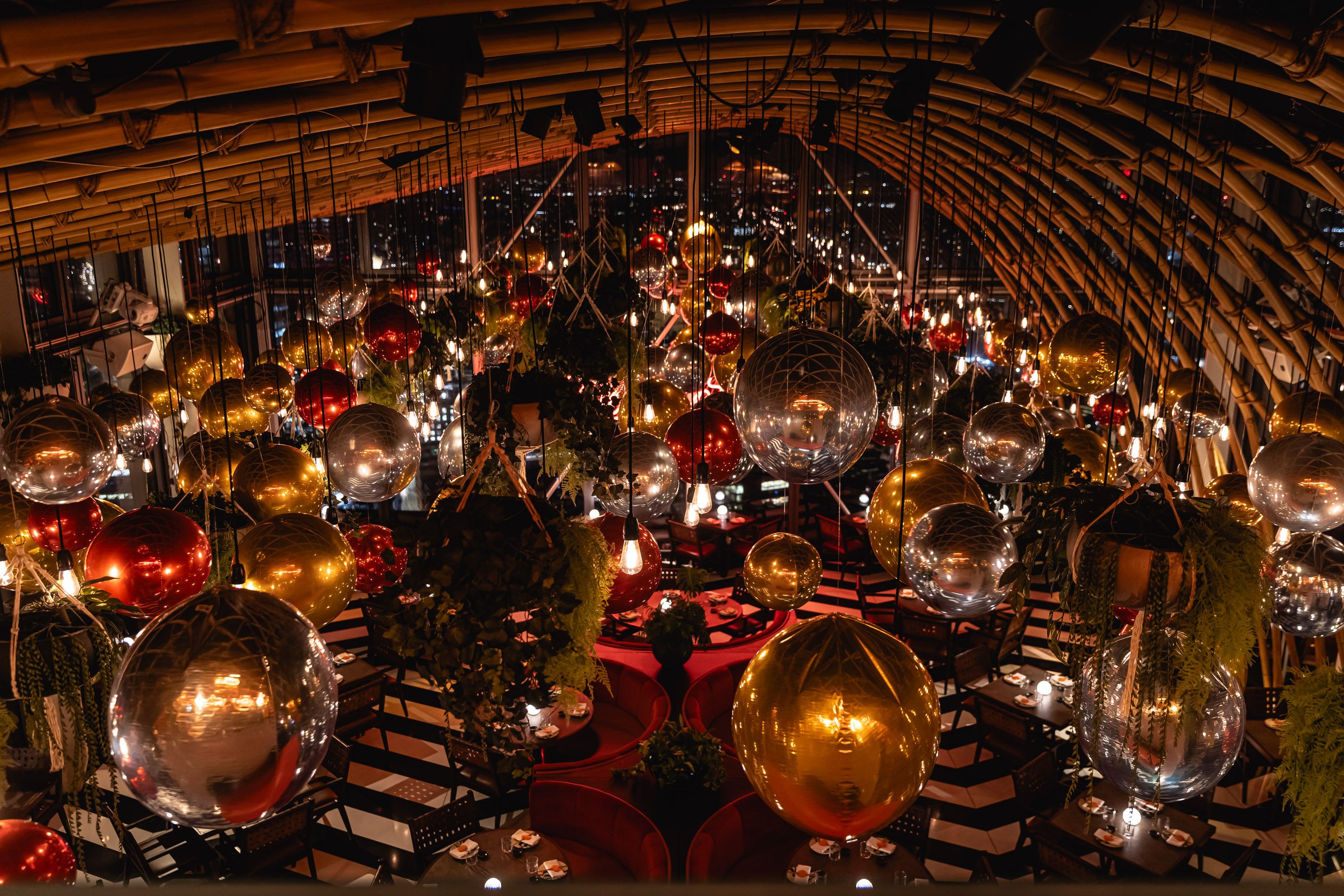 FESTIVE DECORATIONS AT SUSHISAMBA HERON TOWER. IMAGE SHOWS FOIL BALLOONS HANGING FROM THE CEILING