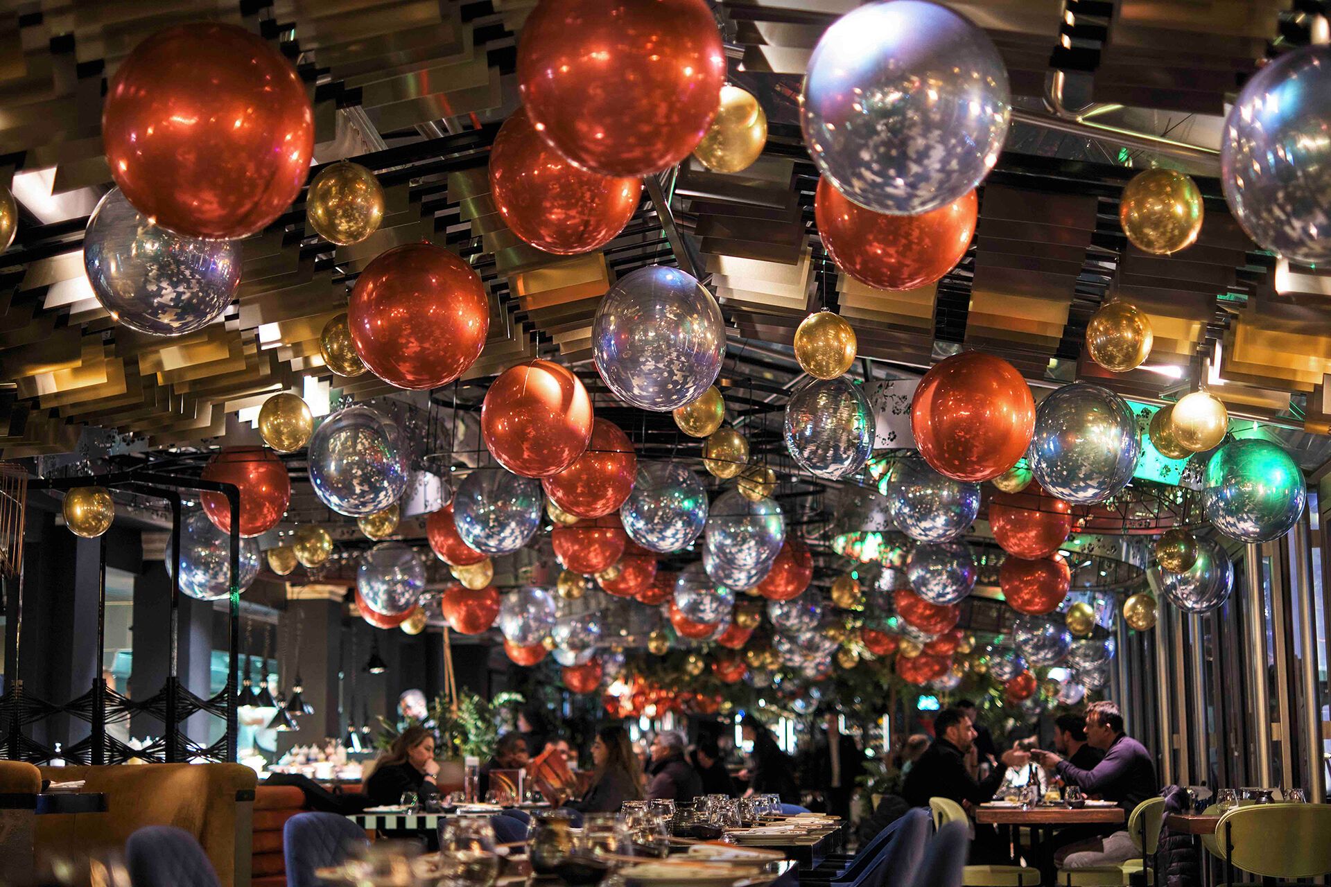 Christmas decorations at SUSHISAMBA Covent Garden, with lots of silver and red balloons.