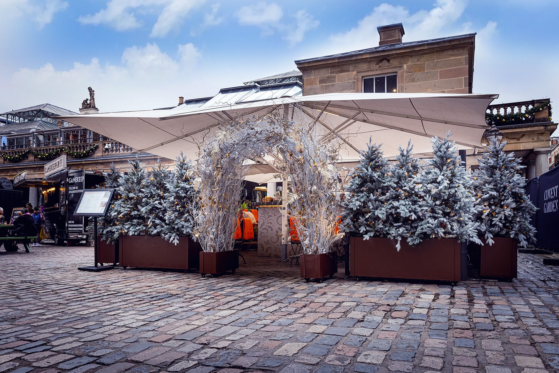 covent garden winter piazza terrace exterior showing fir trees and a frosted archway